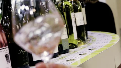 Wine testing with bottles in the background Stock Footage 74176248