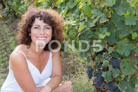 Winegrower happy and smiling woman in vine rows Stock Photos