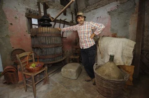 Winemaker at the grapes press Stock Photos