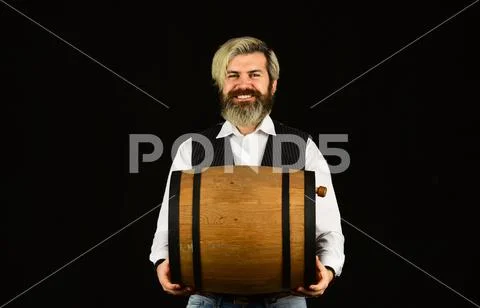 Winery concept. Producing wine family tradition. Man bearded hipster wooden Stock Photos