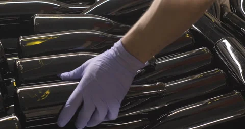 Winery worker in gloves stacking red wine bottles in container for shipping Stock Footage 249844909