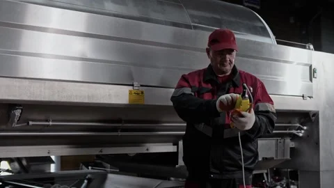 Winery worker operates a huge vacuum pneumatic press to squeeze juice out Stock Footage 271238409