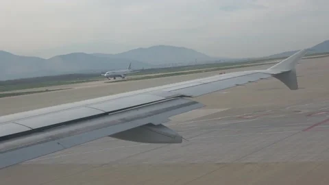 Wing Adjustment while an Aegean Airlines Aircraft is Passing at the Background Stock Footage 141602743
