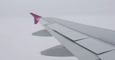 Wing of the aircraft with deflecting flaps during the flight of the aircraft Stock Footage 129995887