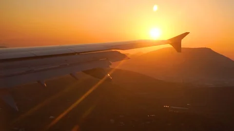Wing of an airplane above clouds in sunset light. Golden background. Stock Footage 103675454