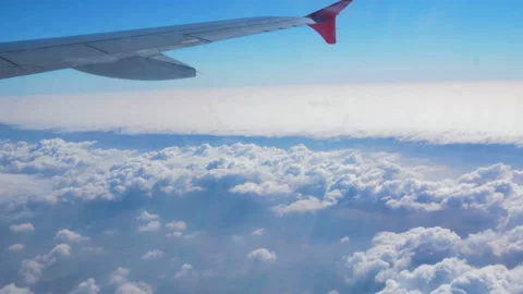 Wing airplane and cloud on sky. View through an airplane window. Stock Footage 89757025