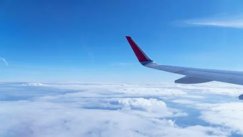 Wing of an airplane in the clouds Stock Photos