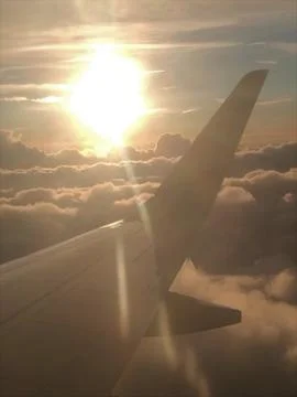 The wing of an airplane with a cloudy background Stock Photos