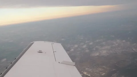 Wing airplane flight white slicing through thin clouds above northern poland Stock Footage 328999555