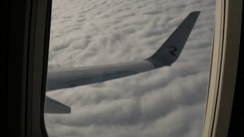 Wing of an airplane flying above the cloud. View from the window of the plane. Stock Footage 120563755