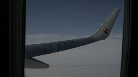 Wing of an airplane flying above the cloud. View from the window of the plane. Stock Footage 120564440