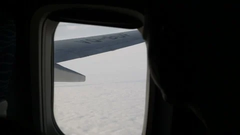 Wing of an airplane flying above the cloud. View from the window of the plane. Stock Footage 120565389