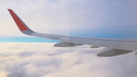 Wing of airplane flying above the clouds. The view from the window on the wing Stock Footage 72256714