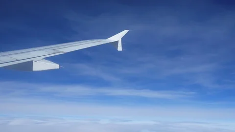 Wing of an airplane flying above the clouds Stock-Footage 97363993