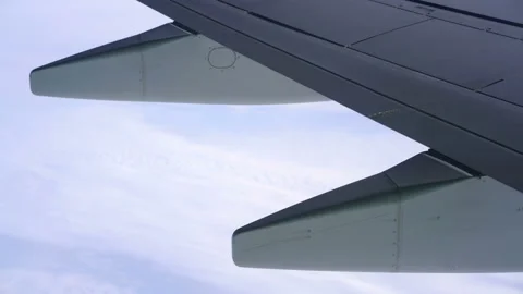 Wing of an airplane flying above the clouds Stock Footage 100815685