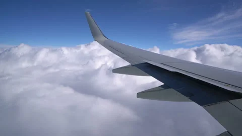 Wing of an airplane flying above the clouds Stock Footage 100815734