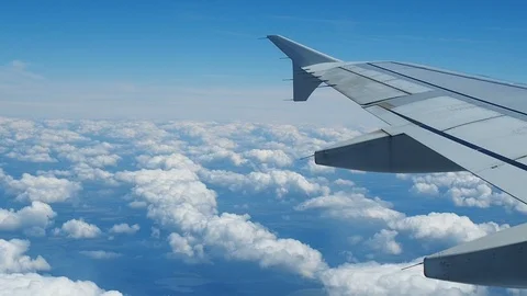 Wing of airplane flying above clouds 動画素材 103181303