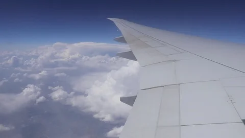 Wing of airplane flying above clouds Video stock 107124759