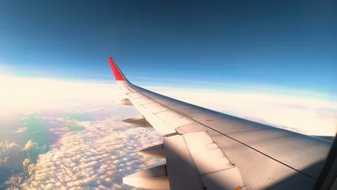 Wing of an airplane flying above the clouds with Cloudy sky. Stock Footage 118083128