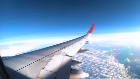 Wing of an airplane flying above the clouds with Cloudy sky. Stock Footage 118084055