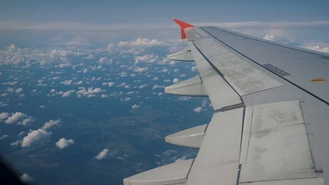 Wing of airplane flying above clouds. View from the window of the plane. Stock-Footage 120602095