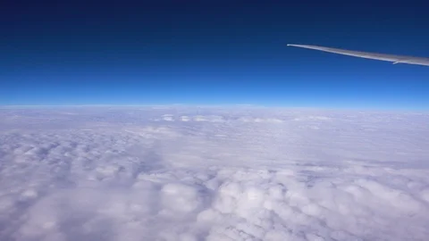 The wing of an airplane flying above the clouds, the view from the window Vídeos de archivo 125240527