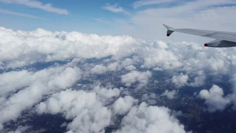 Wing of an airplane flying above clouds Stock Footage 205046045