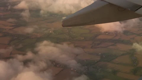 Wing of airplane flying above the clouds with sunset sky Video stock 228866541