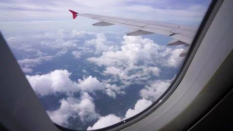 Wing of an airplane flying above clouds Video stock 313652822