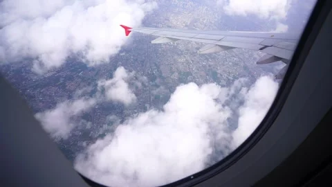 Wing of an airplane flying above clouds Stock Footage 313652838