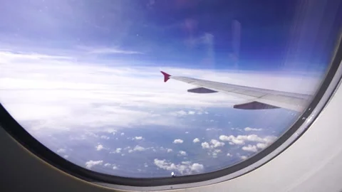 Wing of an airplane flying above clouds Stock Footage 313652839