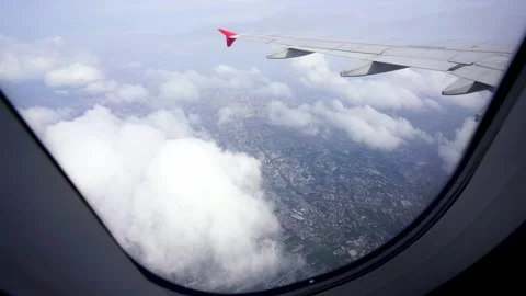 Wing of an airplane flying above clouds Stock Footage 313652844