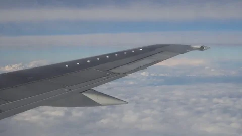 Wing of the airplane flying in blue sky Stock Footage 83642244