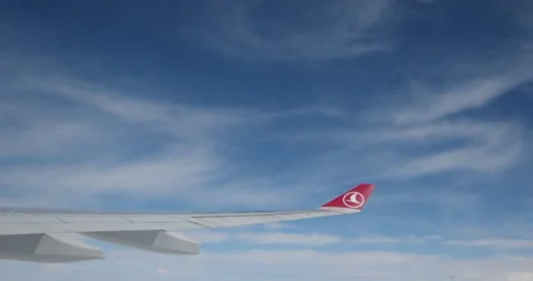 Wing of an airplane flying in the clouds. View from the window. Travelling Stock Footage 263063106