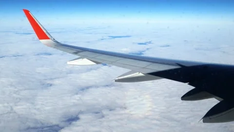 The wing of an airplane flying at dawn in the clouds. Stock Footage 166314773