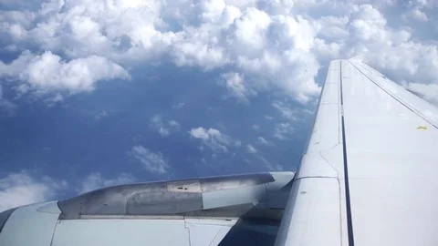 Wing of a airplane flying over clouds Stock-Footage 74097373