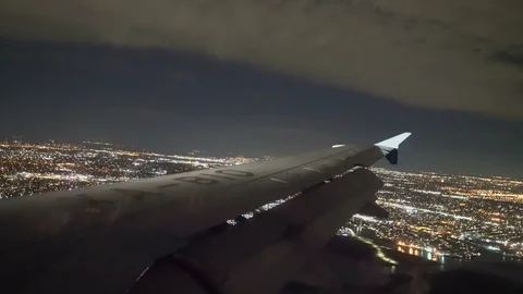 Wing Of An Airplane Flying over Clouds at Night Stock Footage 105036685