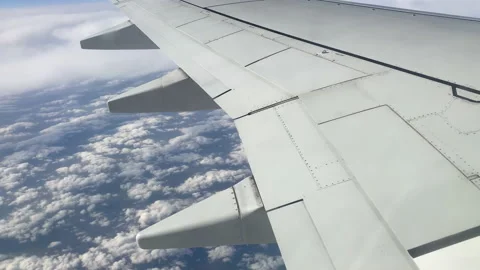 The wing of an airplane flying in the sky. View from the porthole Stock Footage 172110613