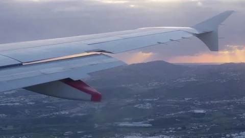 Wing of airplane flying under the clouds on a cloudy day 4k Stock Footage 75186683