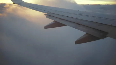 The wing of an airplane looking through the passenger window 4K Stock Footage 130284105