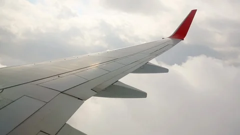 Wing of an airplane in the sky Stock Footage 94977468