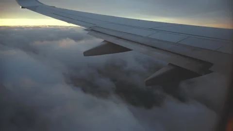 The wing of an airplane at sunset 4K Stock Footage 130283334