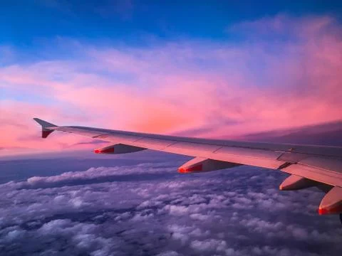 Wing of an Airplane at Sunset Stock Photos