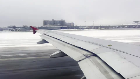Wing of an airplane taking off in winter Stock Footage 241801192