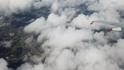 Wing of an airplane turning above clouds Stock Footage 205046776