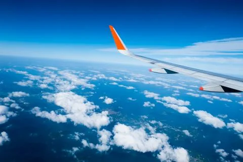 Wing of airplane from window Stock Photos