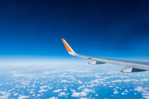 Wing of airplane from window Stock Photos