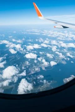 Wing of airplane from window Stock Photos