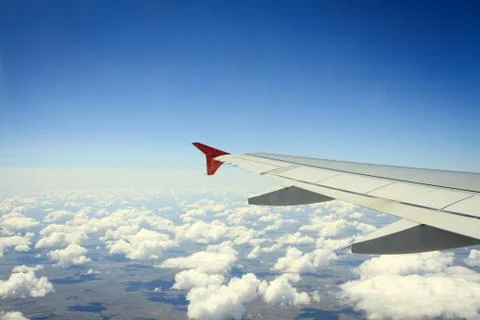 Wing of airplane from window Stock Photos