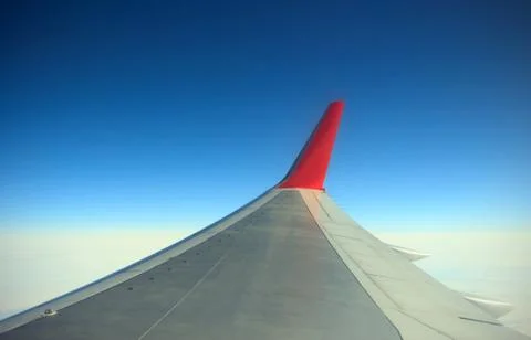 Wing of airplane from window Stock Photos